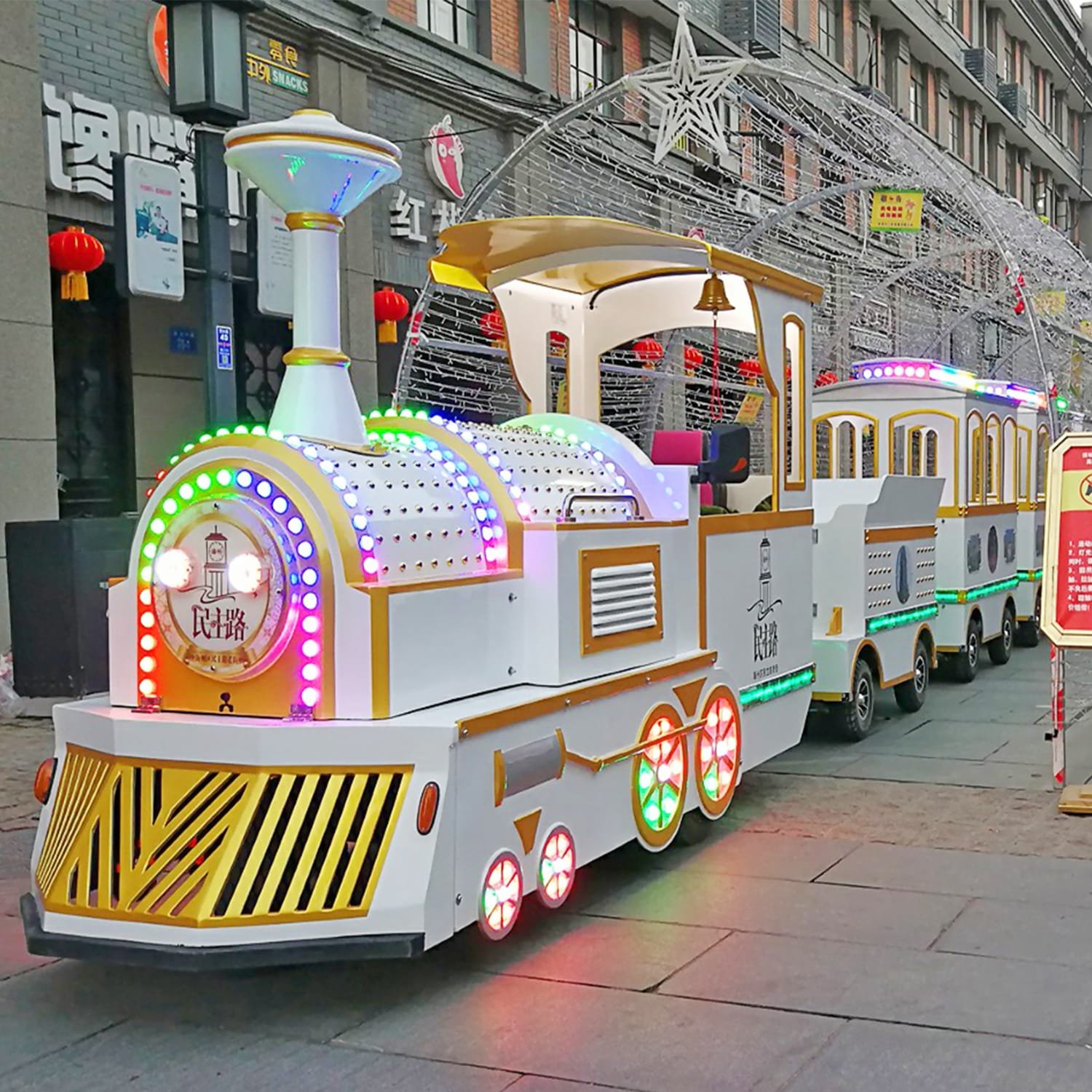 Sightseeing Train for Sale: 16–72 Seat Models & Real Prices 16-seat electric sightseeing train with LED lighting operating on a pedestrian commercial street