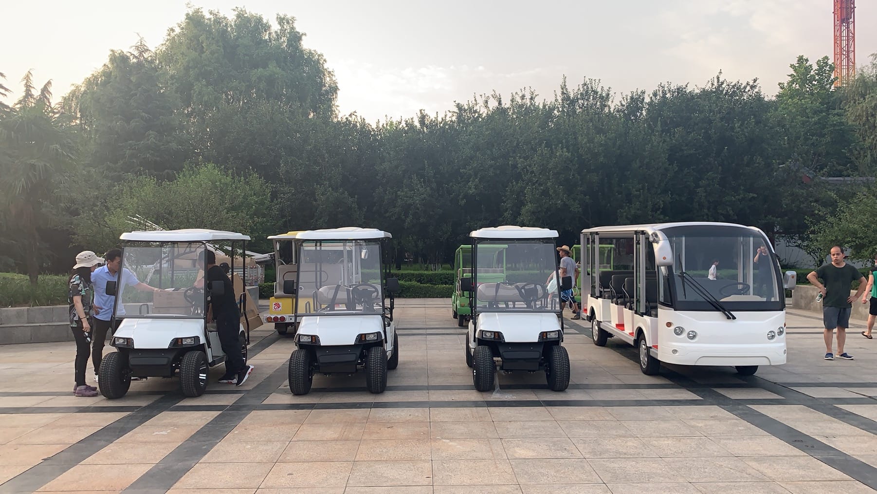 Colorful sightseeing cars in a scenic park with tourists enjoying the ride