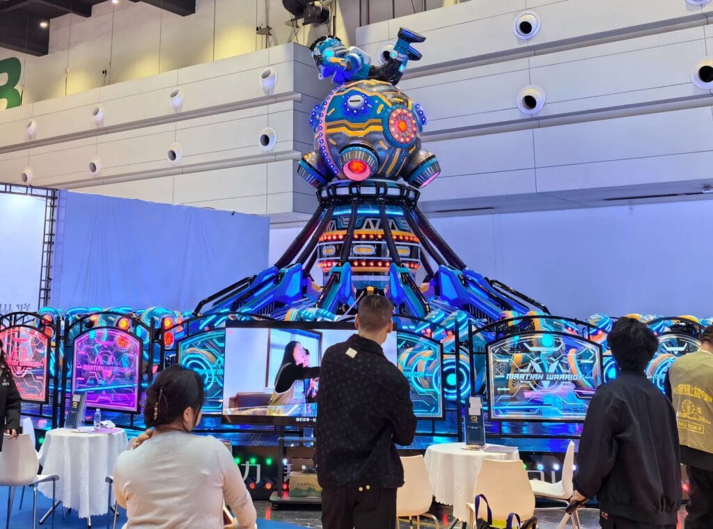 International buyers experiencing the 2026 new Martian Warrior self-control plane ride during JHRides experience day and factory open tour.