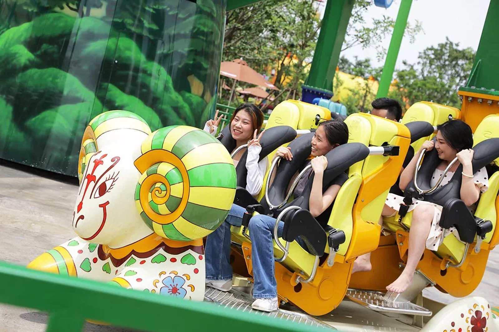 Children riding self-control plane ride with parents in a park