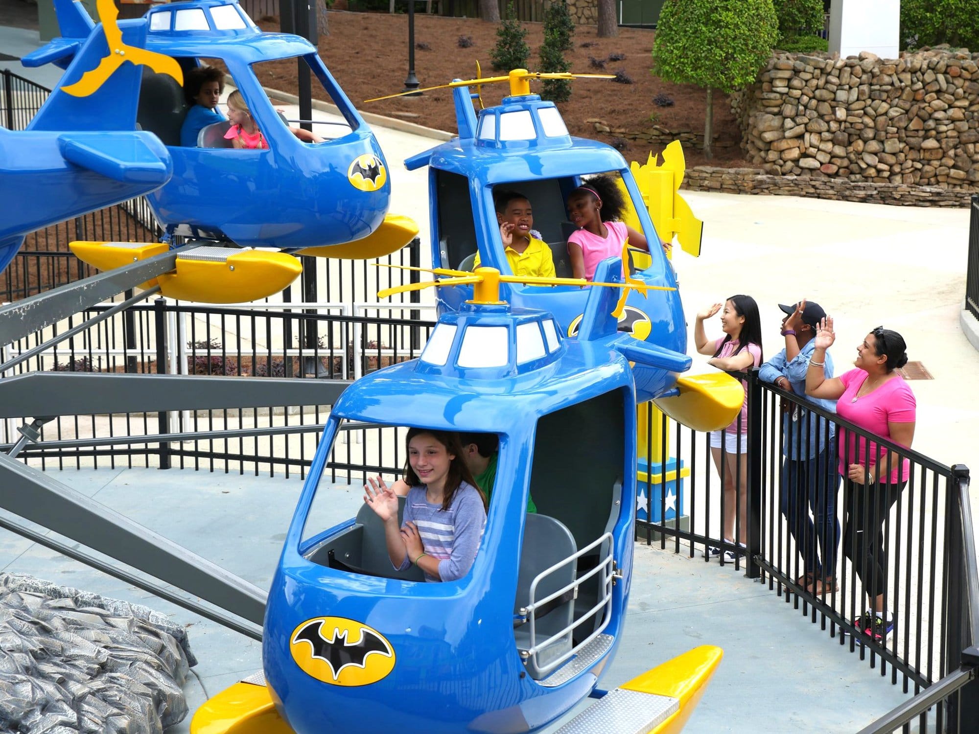 Self Control Plane Amusement Ride Batman helicopter self control plane rides happy riders close-up