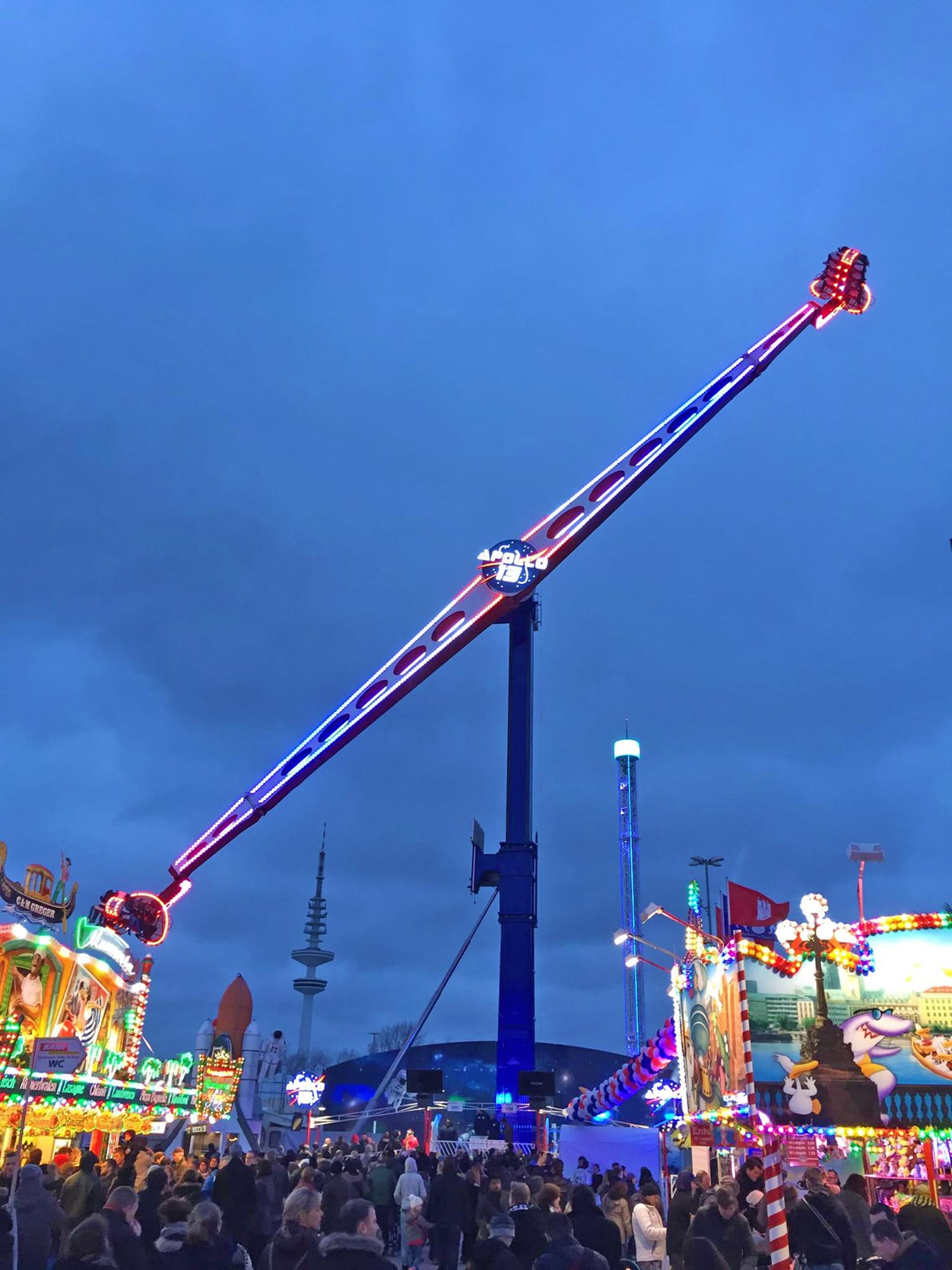 Crazy Booster extreme thrill ride in action at a carnival