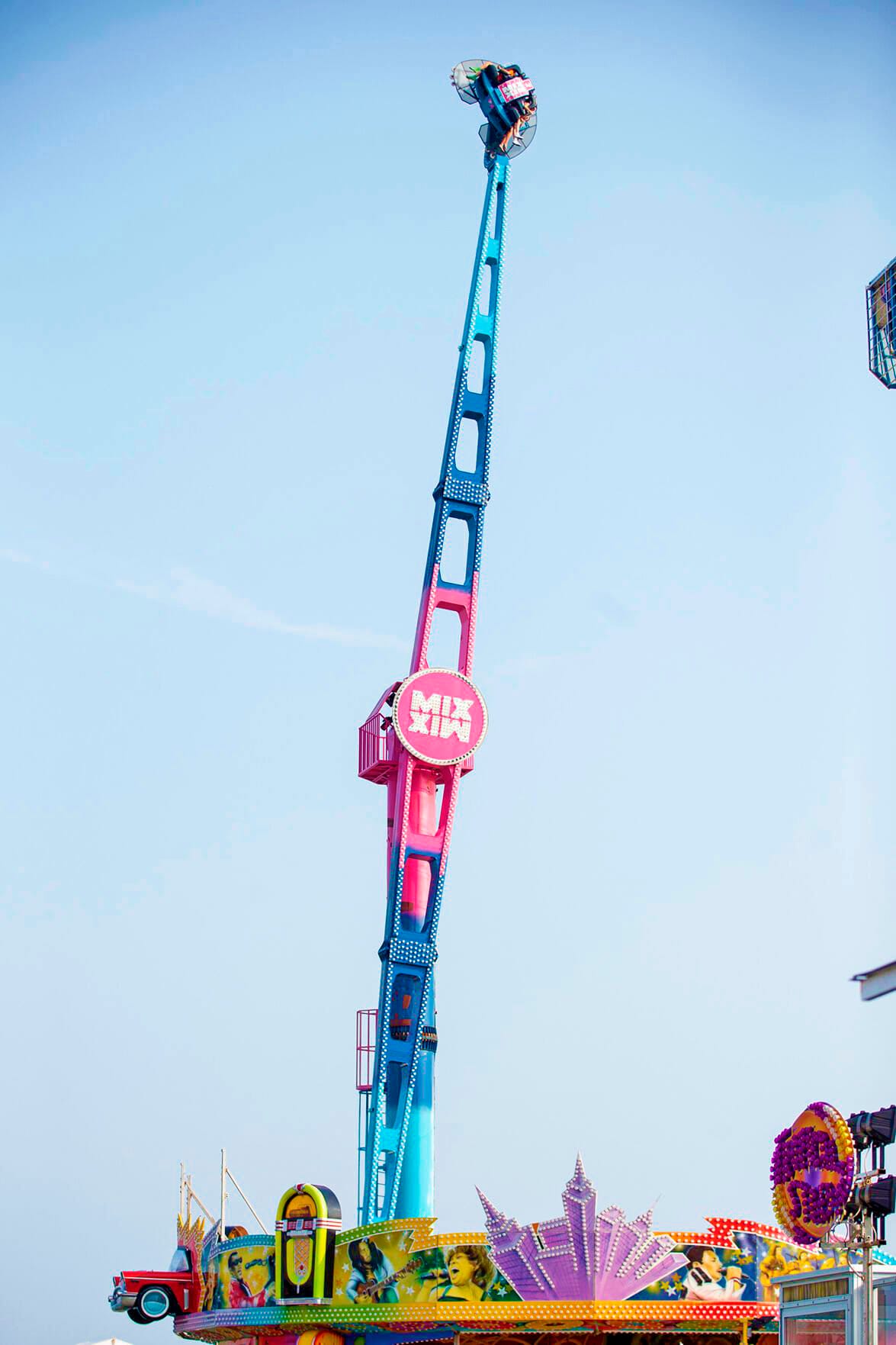 Crazy Dance large amusement ride with riders at peak height