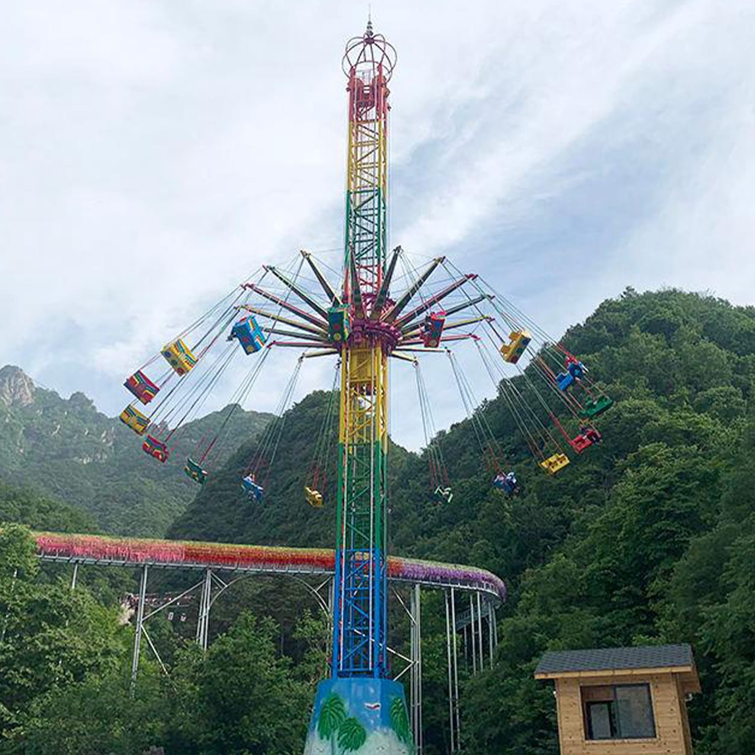 Flying Tower thrill ride with riders enjoying the rotating ascent