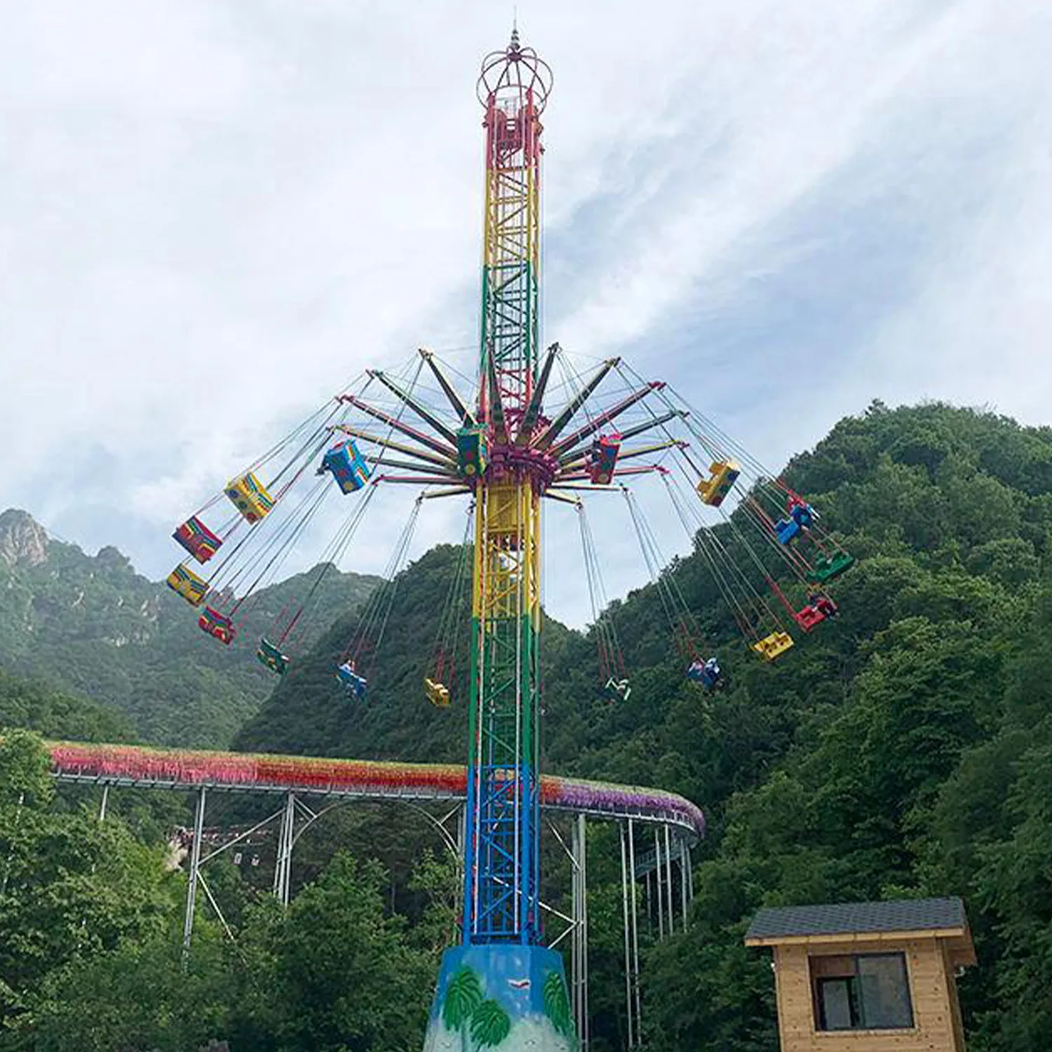 Flying Tower thrill ride with riders enjoying the rotating ascent