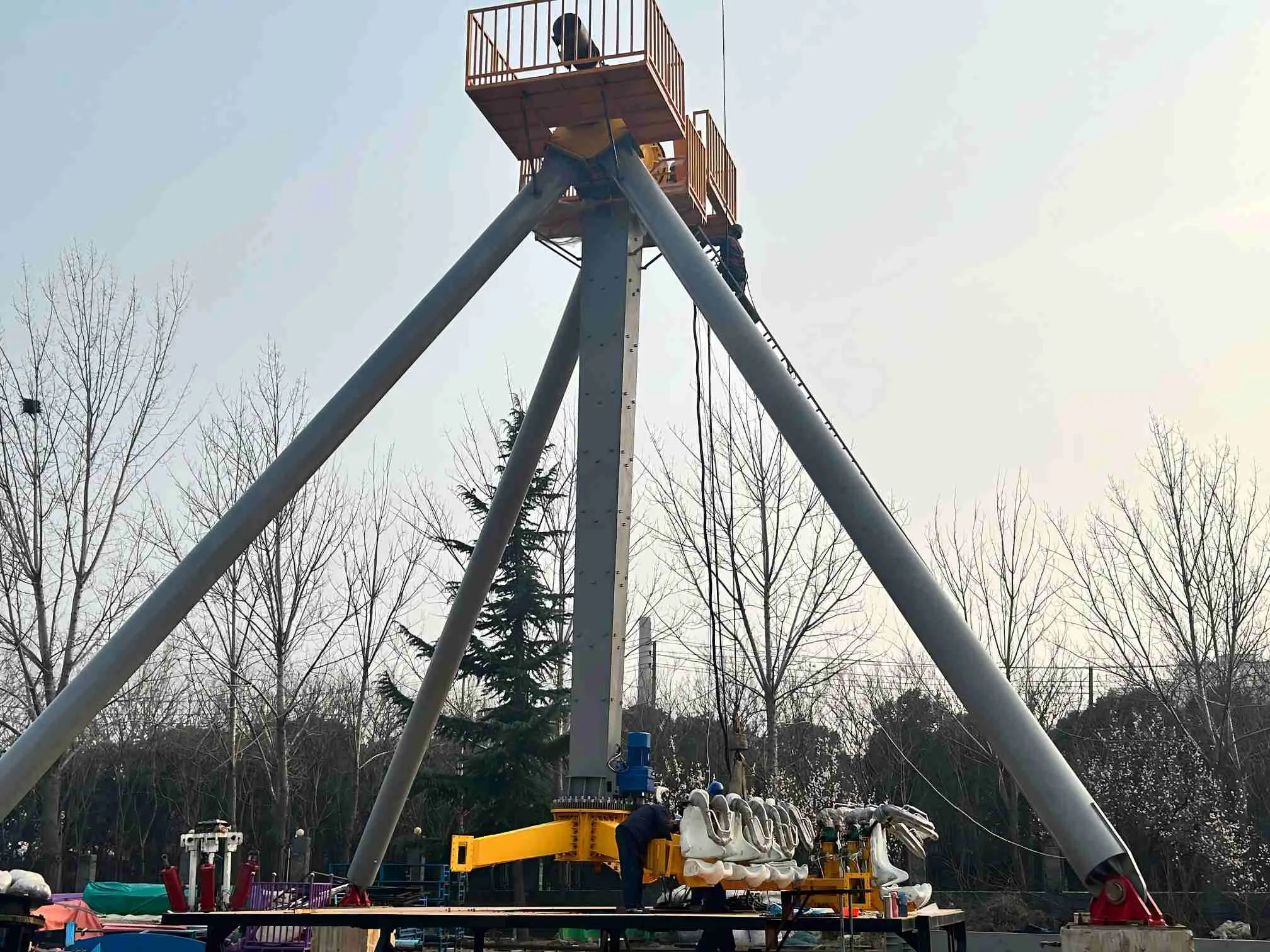 Everything You Need to Know About Pendulum Rides: Price, Care, and Worldwide Records Technician inspecting a pendulum ride mechanism