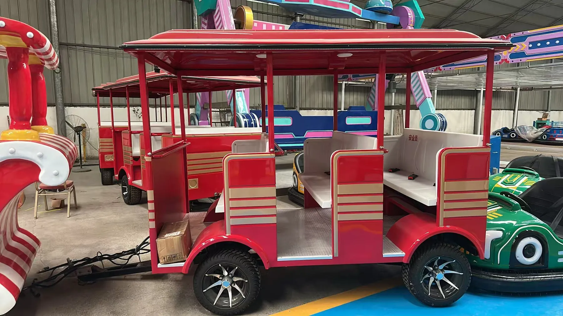 Trackless vs Track Train: Specs, Costs & How to Choose 42-seat trackless train open passenger carriages with canopy roofs inside the factory