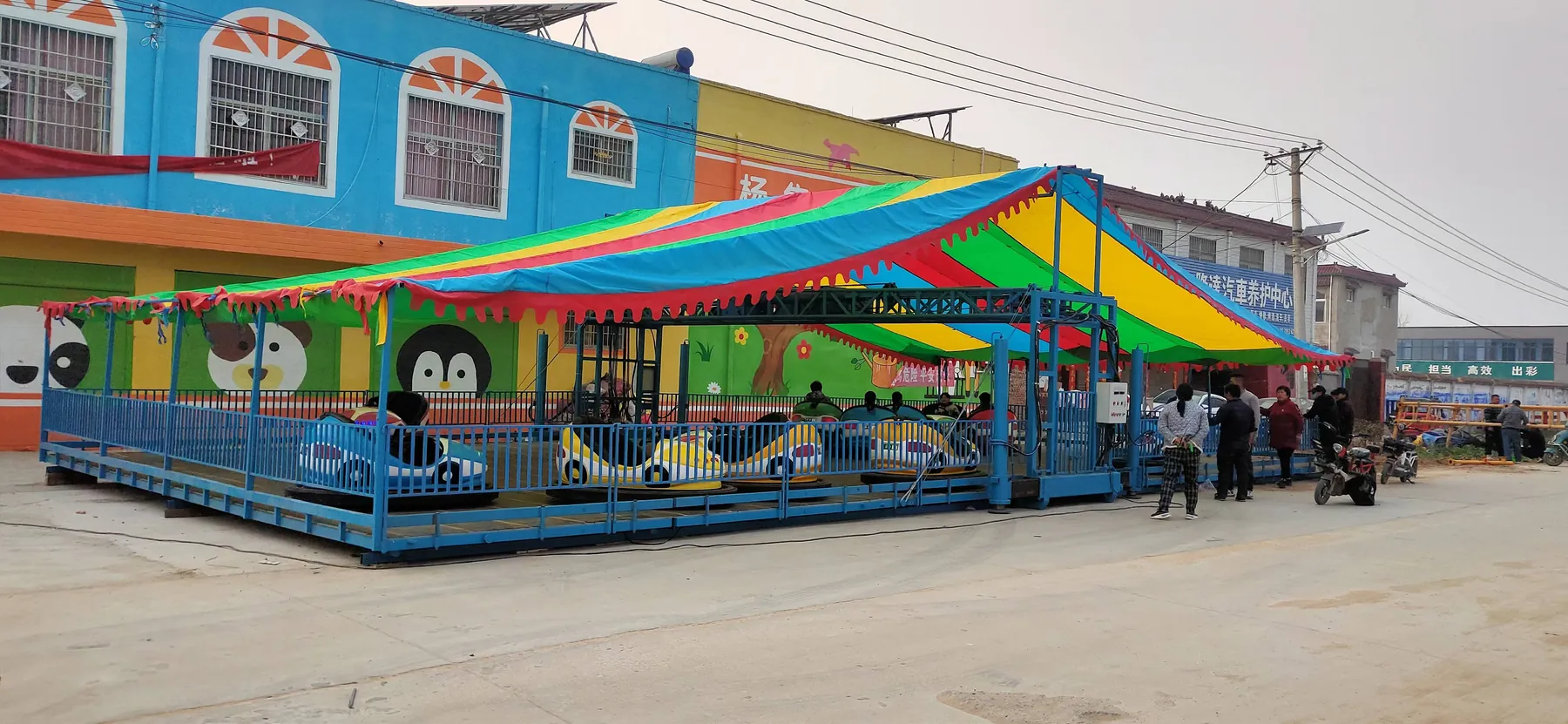 Folded mobile bumper car arena on a flatbed trailer ready for transport
