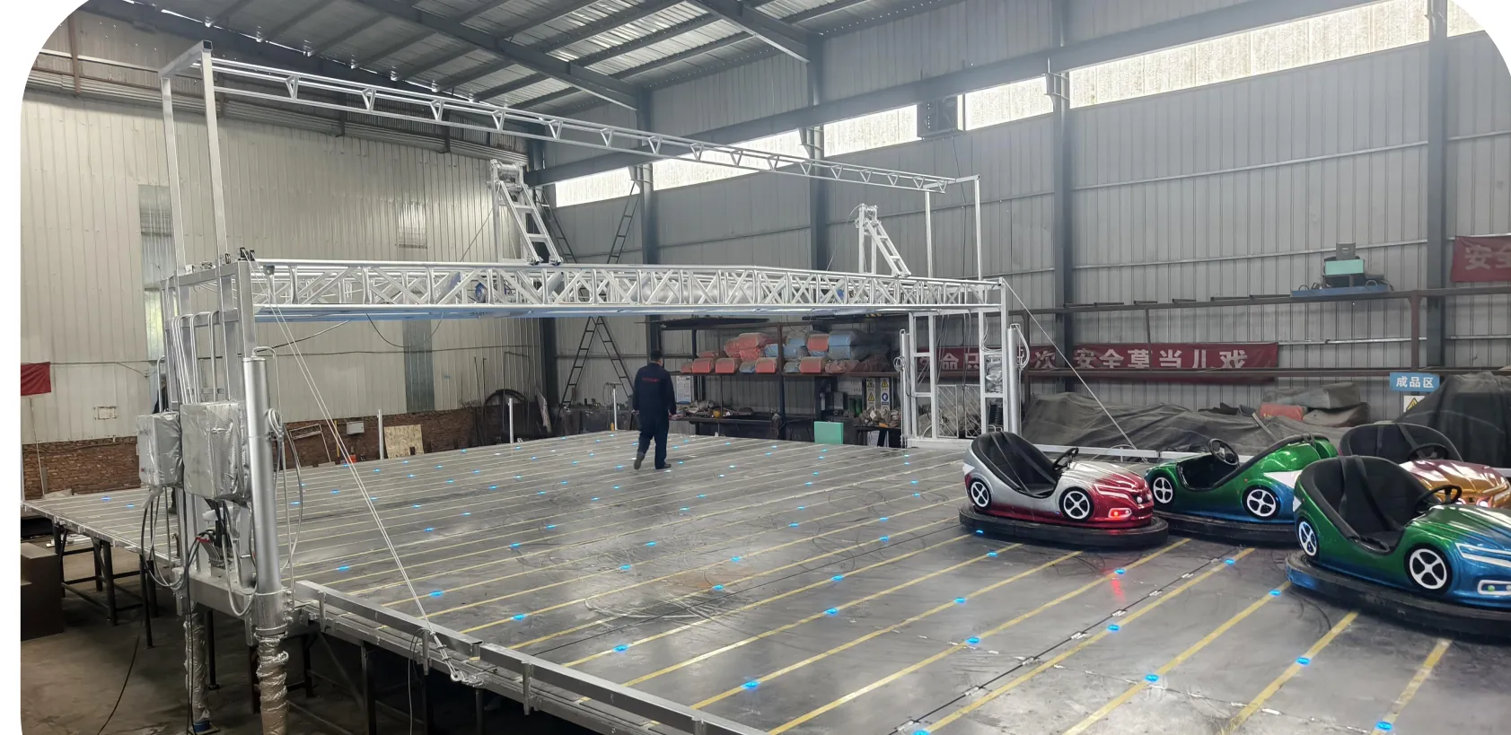 Mobile ceiling-grid bumper car arena with aluminum truss overhead grid in factory